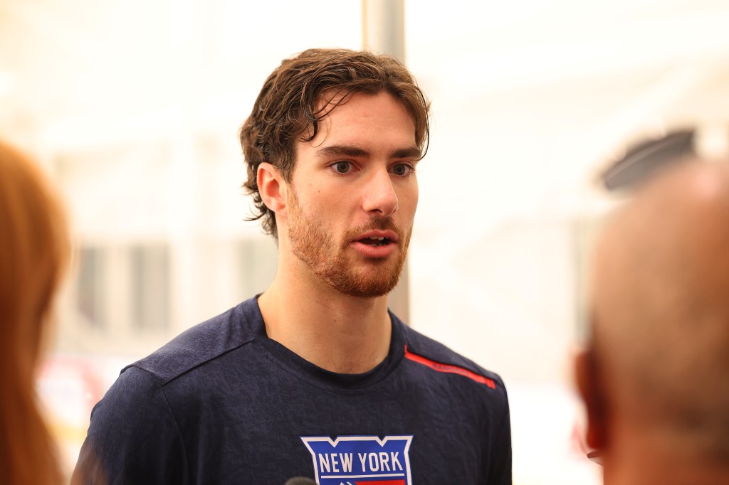 New York Rangers rookie Dylan Garand in a navy blue shirt with a red stripe.