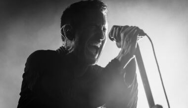 Trent Reznor performing live on stage with Nine Inch Nails during a concert.