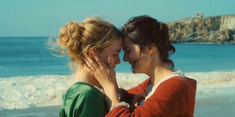 Noémie Merlant holds Adèle Haenel's face in her hands and touches foreheads in Portrait of a Lady on Fire.