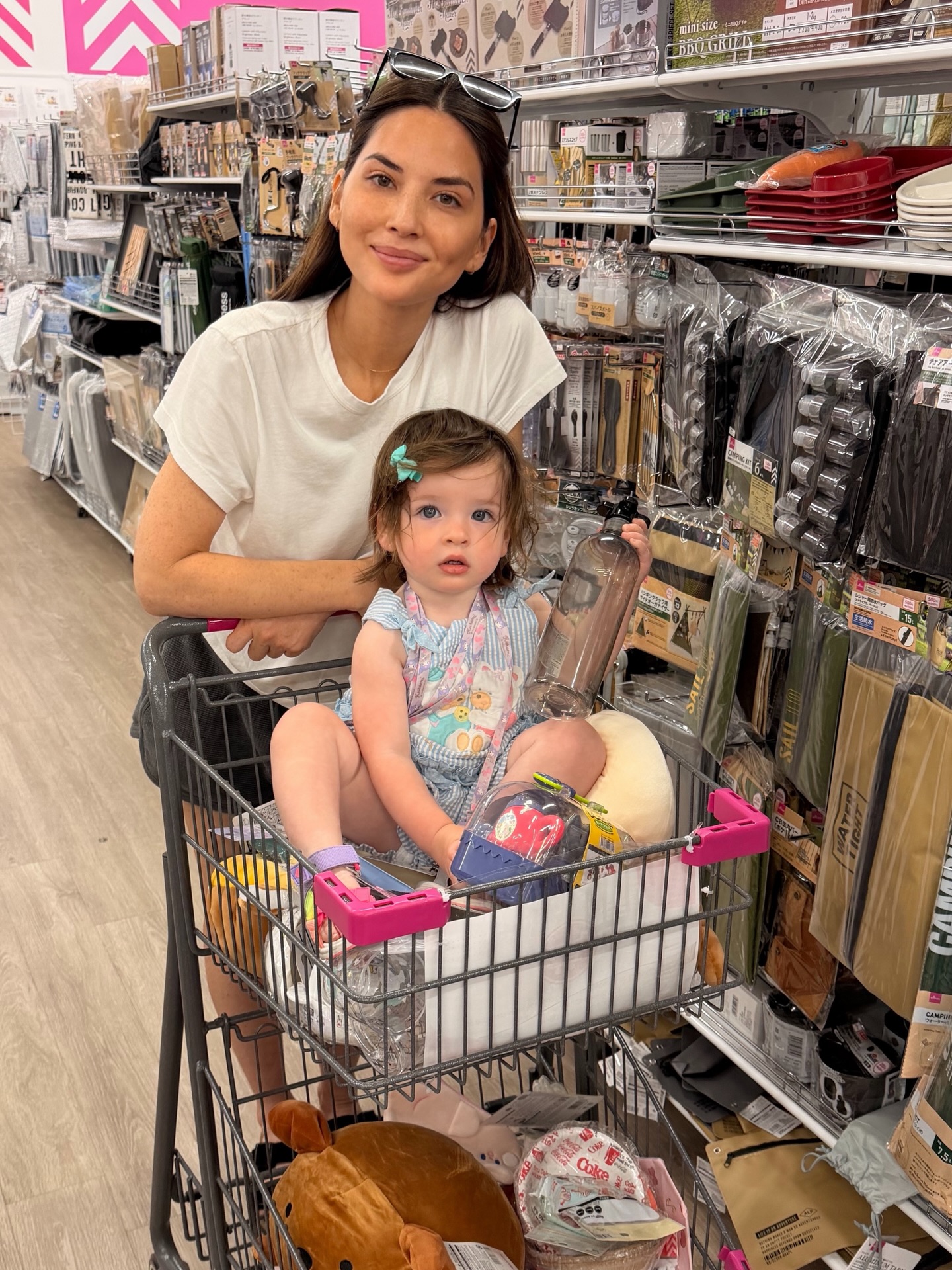 Olivia Munn (left) and her 1-year-old daughter, Mei, load up their cart during a  shopping trip.