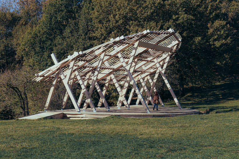 palcosole by grriz raises a half sun of timber above a historic park to gather community and light 3