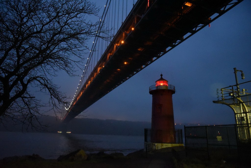 The Little Red Lighthouse helps illuminate the Hudson River under the George Washington Bridge,