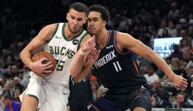 Milwaukee Bucks forward Pete Nance drives on Phoenix Suns forward Oso Ighodaro (11) during the first half of an NBA basketball game, Saturday, March 21, 2026, in Phoenix.