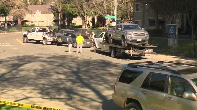 A sedan and a truck are being towed as officers investigate a series of Sacramento shootings on March 4, 2026.