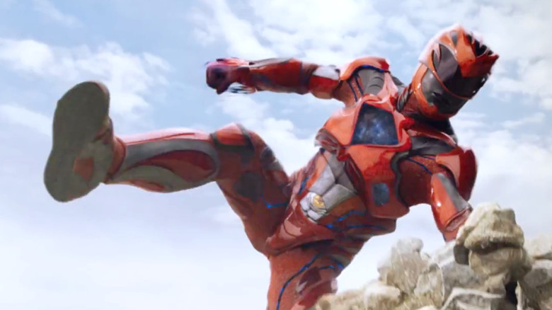 The Red Ranger vaulting over some rocks in Power Rangers (2017)