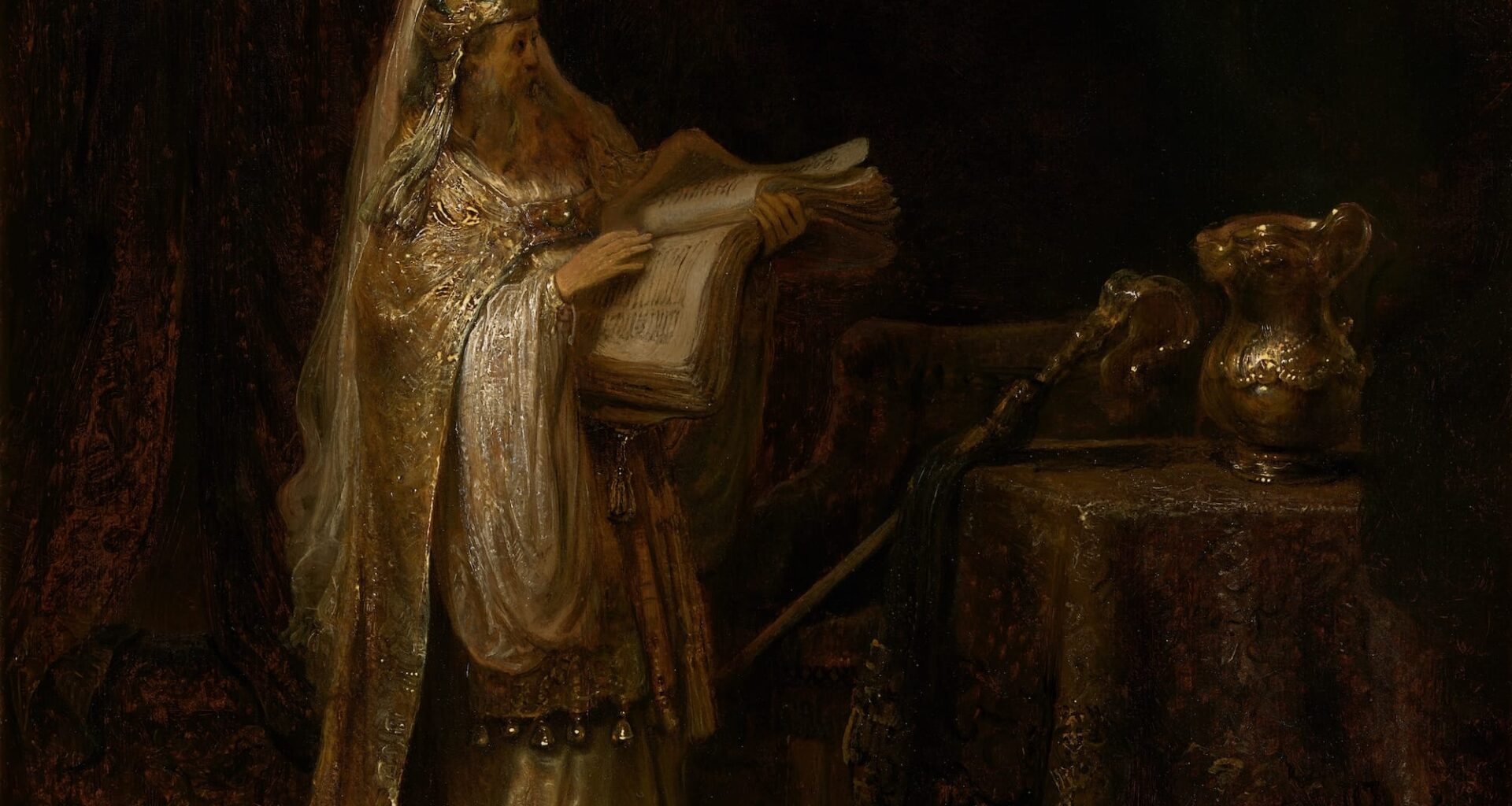 A 17th-century oil painting by Rembrandt of a priest looking at a large book in a temple