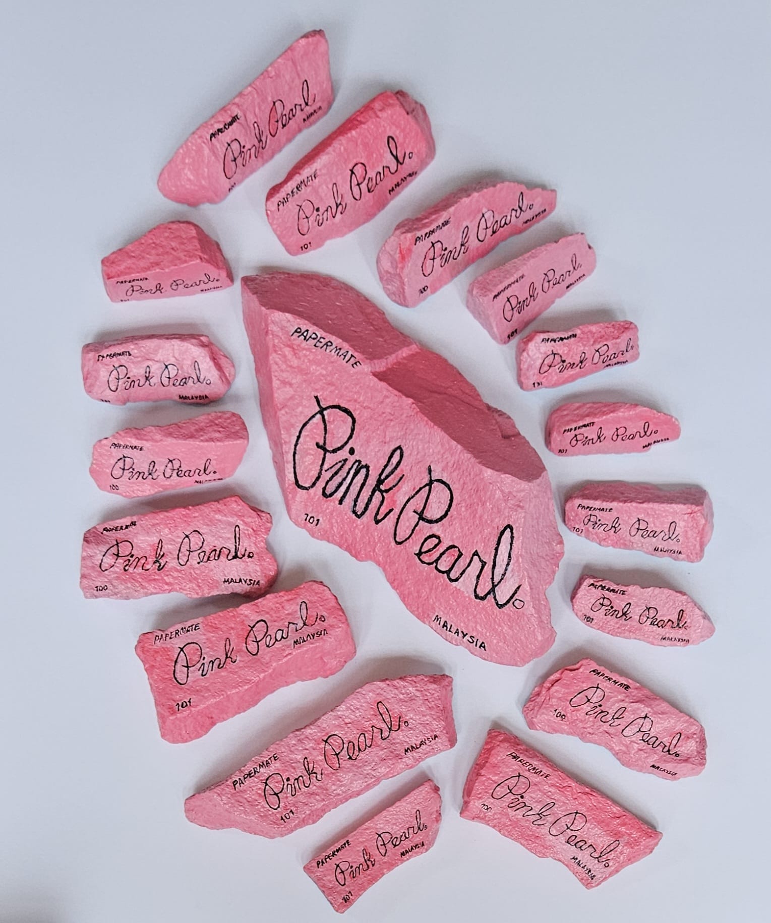 Painted rocks by Elizabeth Saloka that resemble a number of Pink Pearl erasers