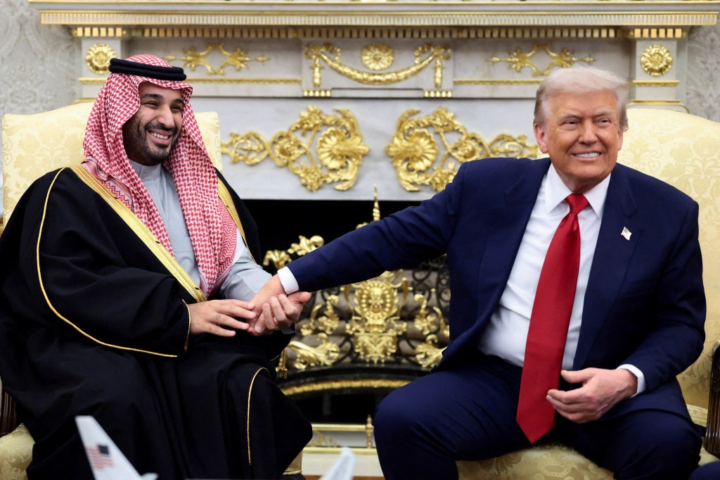 Saudi Crown Prince and Prime Minister Mohammed bin Salman holds President Trump's hand during a meeting in the Oval Office at the White House in Washington, DC, on Nov. 18, 2025.