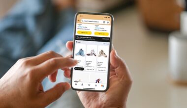 person holding mobile phone with Shop Direct on screen