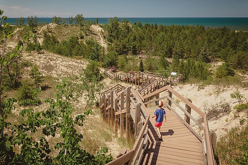 A boy hiking along a trail in the Indiana Dunes National Park, Indiana.