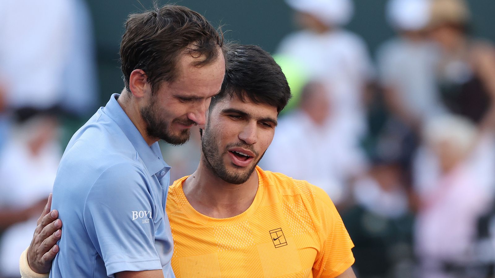Carlos Alcaraz of Spain, right, hugs Daniil Medvedev after being defeated during their Men's Singles Semifinals match on Day 11 of the BNP P