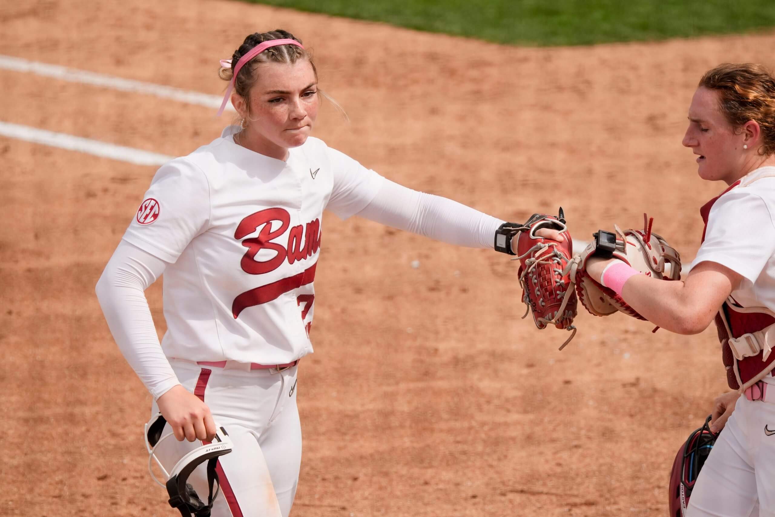 Alabama pitcher Jocelyn Briski and catcher Marlie Giles slap gloves after Briski struck out an Arkansas batter to end an inning at Rhoads Stadium. Alabama defeated Arkansas 4-1 on Sunday to claim the series.