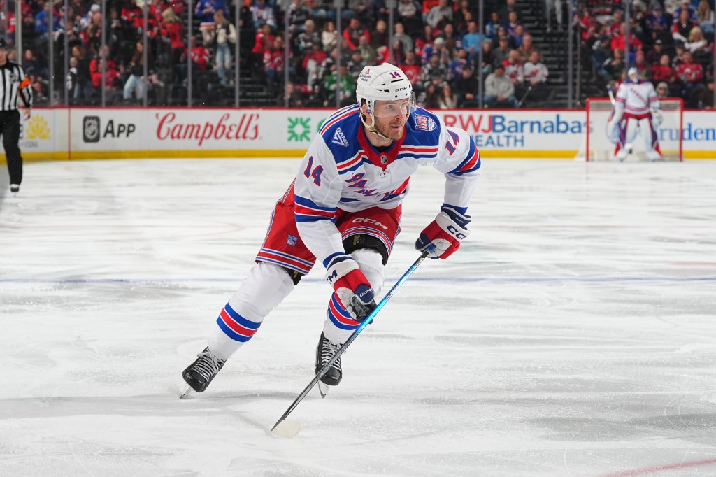 Taylor Raddysh skates across the ice during a New York Rangers game.