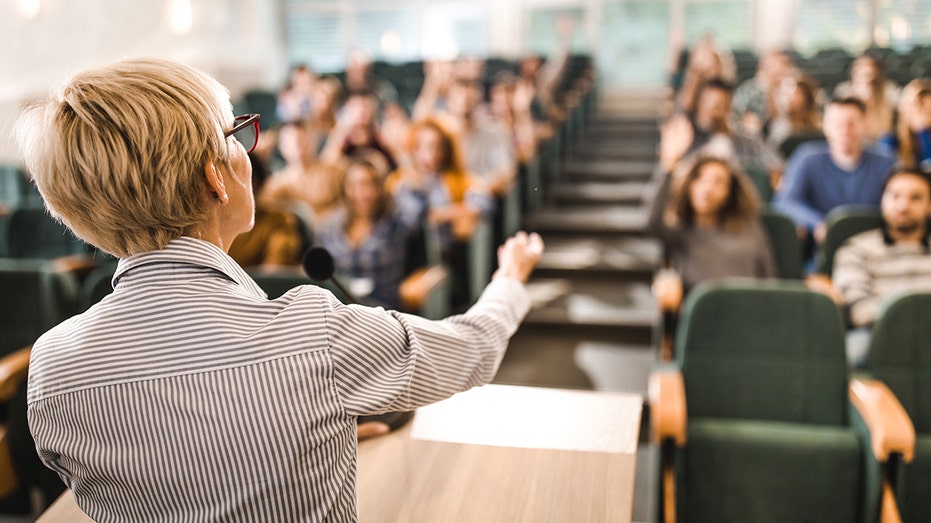 A professor giving a lecture to her class.