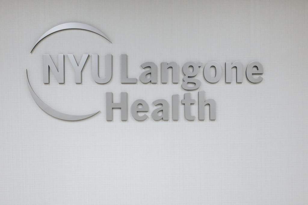 The NYU Langone Health logo displayed on a textured white wall.