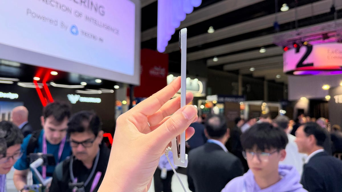 The side of a thin white phone