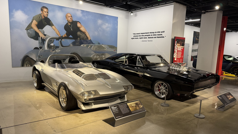 A silver Chevy Corvette and black Dodge Charger at the Petersen museum