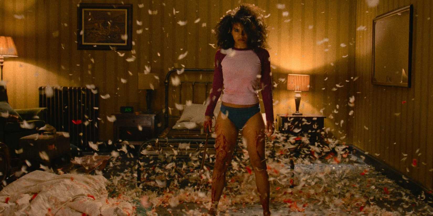 Zazie Beetz covered in blood holding a weapon in They Will Kill You