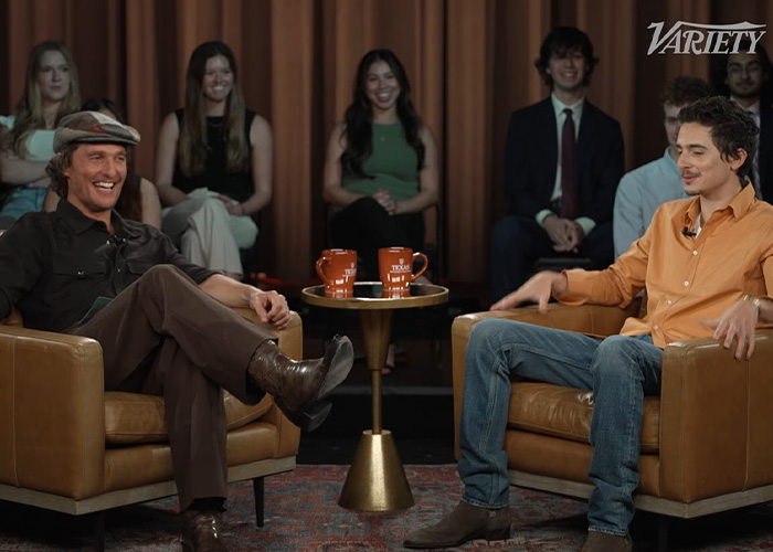 Steven Spielberg and Timothée Chalamet seated in armchairs during an interview with audience in the background. Steven Spielberg and Timothée Chalamet seated in armchairs during an interview with audience in the background.