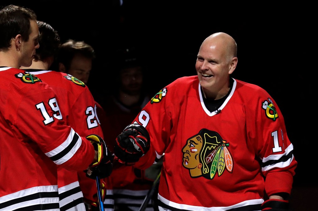 Troy Murray, right, greets Chicago Blackhawks center Jonathan Toews before an NHL hockey game against the Ottawa Senators, Wednesday, Feb. 21, 2018.