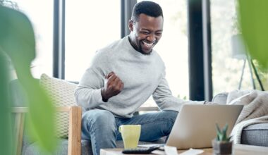 Person cheering in front of laptop.