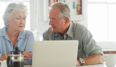 Two people at a laptop.