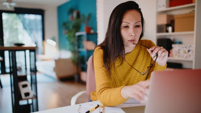 Middle aged woman working from home office.