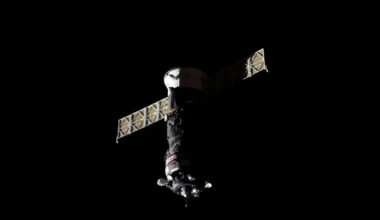 photo of a gray cylindrical spacecraft in deep space