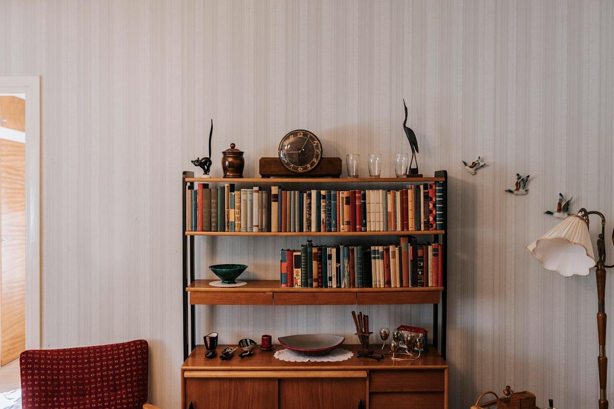 books and antiques arranged in shelf at home