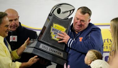 Illinois coach Bret Bielema is presented with the Music City Bowl trophy after defeating Tennessee in an NCAA college football game on Dec. 30, 2025, in Nashville, Tennessee.