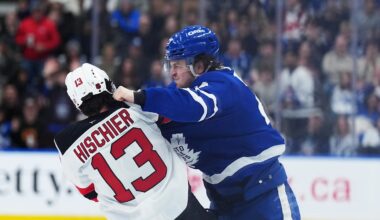 Toronto Maple Leafs left wing Matthew Knies (23) fights with New Jersey Devils center Nico Hischier (13): Nick Turchiaro-Imagn Images