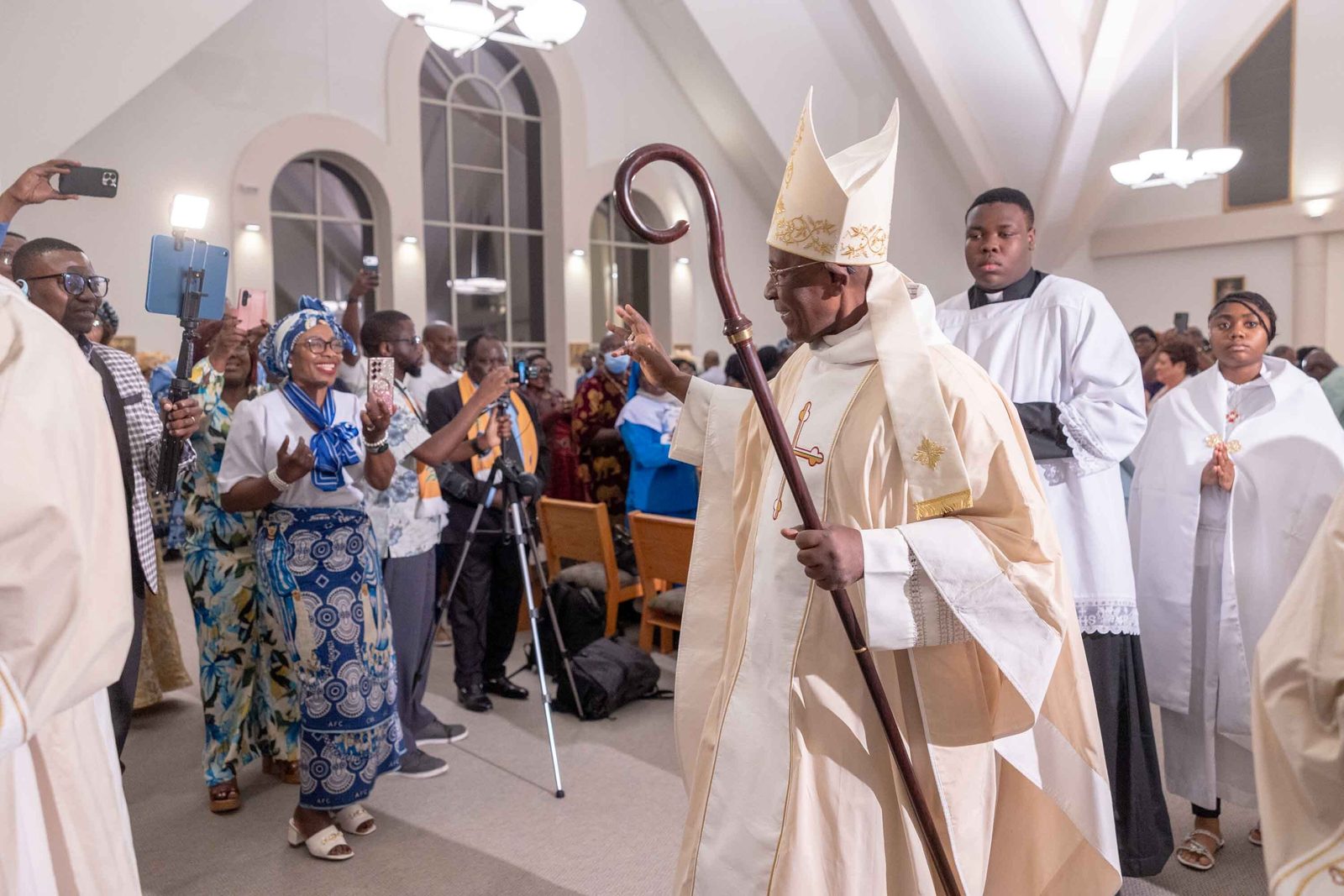 Bishop Jerome Feudjio of the Diocese of St. Thomas in the U.S. Virgin Islands offers a blessing to people as he processes from the altar after celebrating a Mass of Thanksgiving at St. Joseph Catholic Church in Beltsville, Maryland, on April 17, 2026 that commemorated the bishop’s 70th birthday and his fifth anniversary leading that diocese. (Catholic Standard photo by Mihoko Owada)