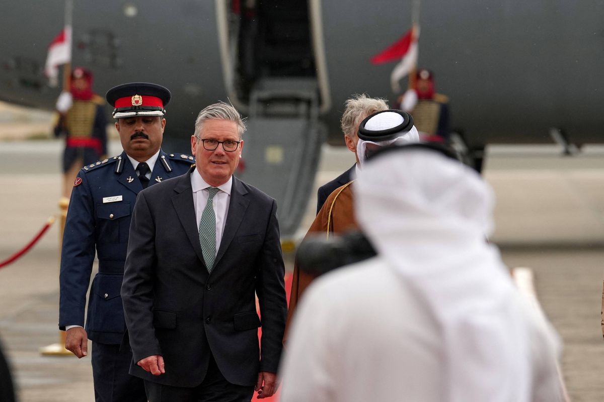 Britain's Prime Minister Keir Starmer (L) is welcomed at an airport at an undisclosed location in Bahrain on April 9, 2026. (Photo by Alastair Grant / POOL / AFP via Getty Images)