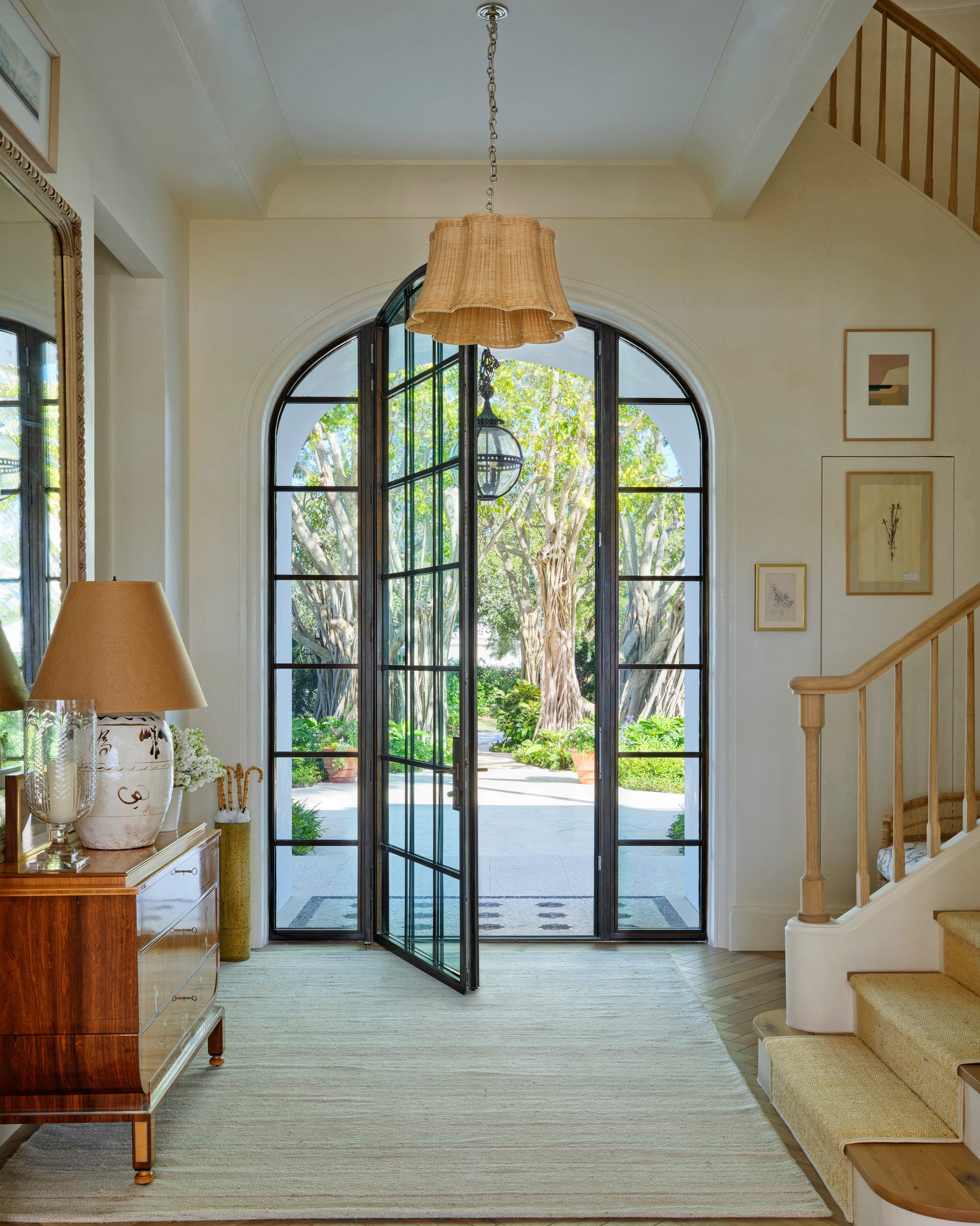 Entryway with open double doors leading to a garden.