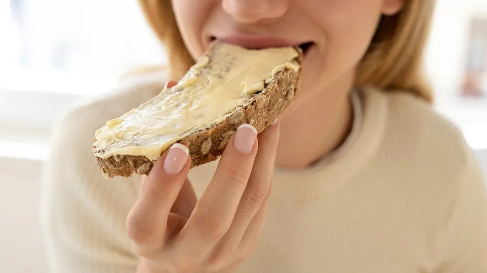 Woman eating breakfast at a table
