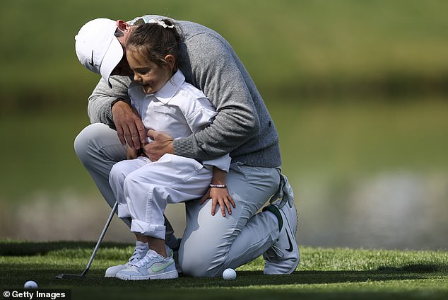 McIlroy embraces daughter Poppy during the annual par-three event at the Masters on Wednesday