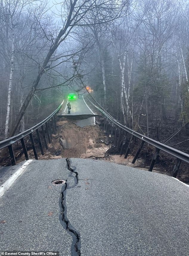 The M-119 between Island View and Division Road was closed after part of the roadway collapsed 'presumably due to flooding' as Michigan is placed under several flood warnings