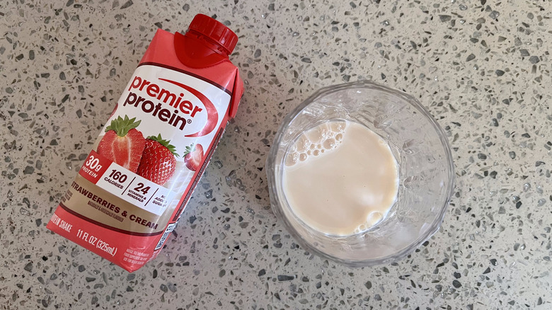 Strawberries & Cream bottle with a glass cup