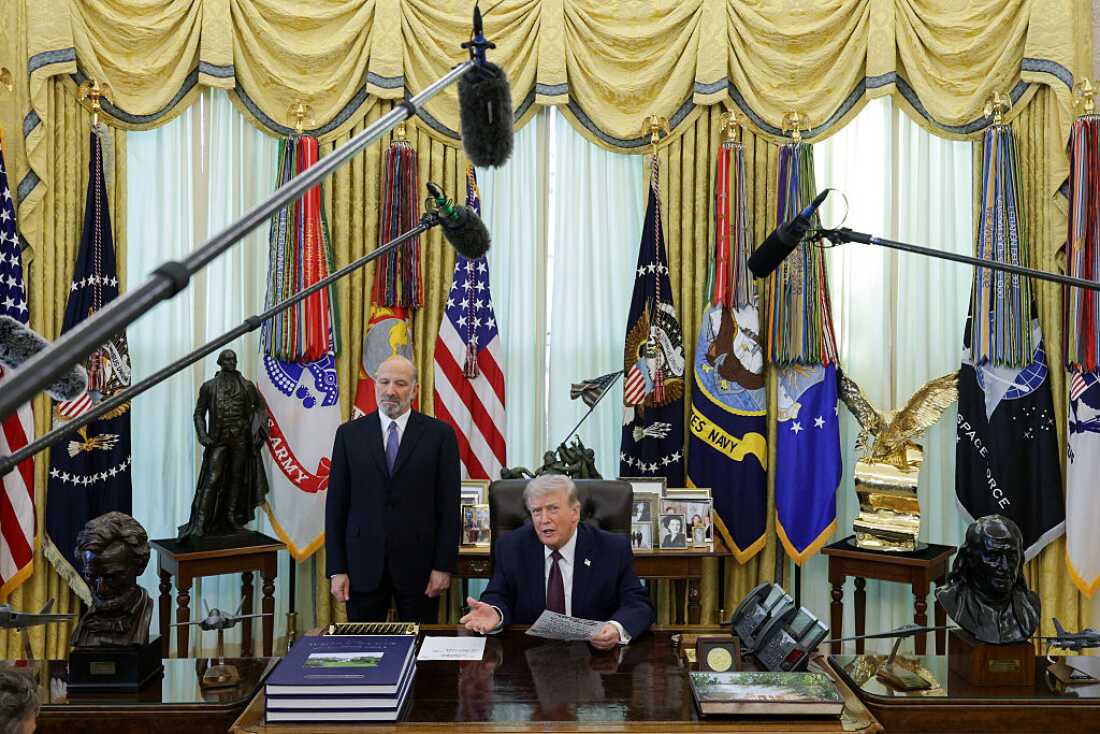 U.S. President Donald Trump (R) speaks after signing an executive order to limit mail-in voting as U.S. Secretary of Commerce Howard Lutnick looks on in the Oval Office of the White House on March 31, 2026 in Washington, DC.