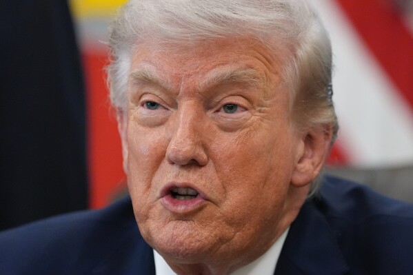 President Donald Trump answers questions from reporters after signing an executive order in the Oval Office of the White House Tuesday, March 31, 2026, in Washington. (AP Photo/Alex Brandon)