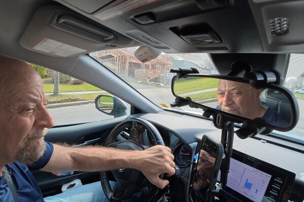 Retiree Stu Goldberg prepares to pick up passengers for Uber near Plainview, N.Y., on Tuesday, March 31, 2026. (AP Photo/Emily Wang Fujiyama)
