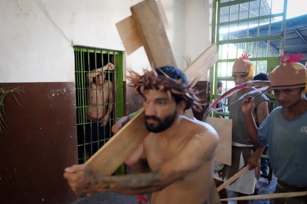 Inmates perform a Stations of the Cross reenactment at Tacumbu prison in Asuncion, Paraguay, Tuesday, March 31, 2026. (AP Photo/Jorge Saenz)