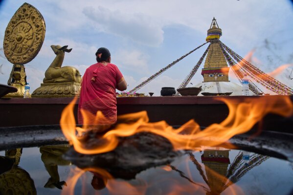 A Tamang community woman pays homage to her deceased loved ones during the Temal festival at Boudhanath Stupa in Kathmandu, Nepal, Wednesday, April 1, 2026. (AP Photo/Niranjan Shrestha)