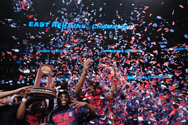 UConn players celebrate after their win against Duke in the Elite Eight of the NCAA college basketball tournament, Sunday, March 29, 2026, in Washington. (AP Photo/Abbie Parr)