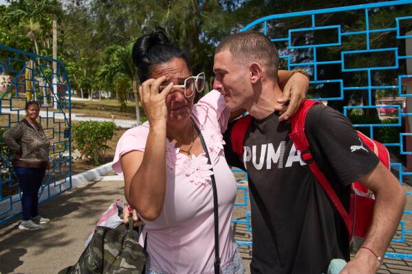 A pardoned prisoner hugs a family member after being released from La Lima penitentiary in Guanabacoa, Havana, Cuba, Friday, April 3, 2026. (AP Photo/Ramon Espinosa)