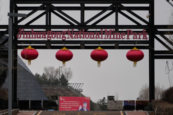A board with a photo of the Chinese President Xi Jinping is displayed at the gate to the Jinhuagong National Mine Park, a museum converted from a former section of the No. 9 mine in Datong, China, Friday, March 13, 2026. (AP Photo/Ng Han Guan)