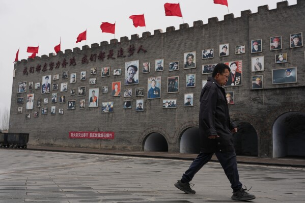 A man walks past a wall of fame for mine workers at the Jinhuagong National Mine Park, a museum converted from a former section of the No. 9 mine, in Datong, China on Friday, March 13, 2026. (AP Photo/Ng Han Guan)