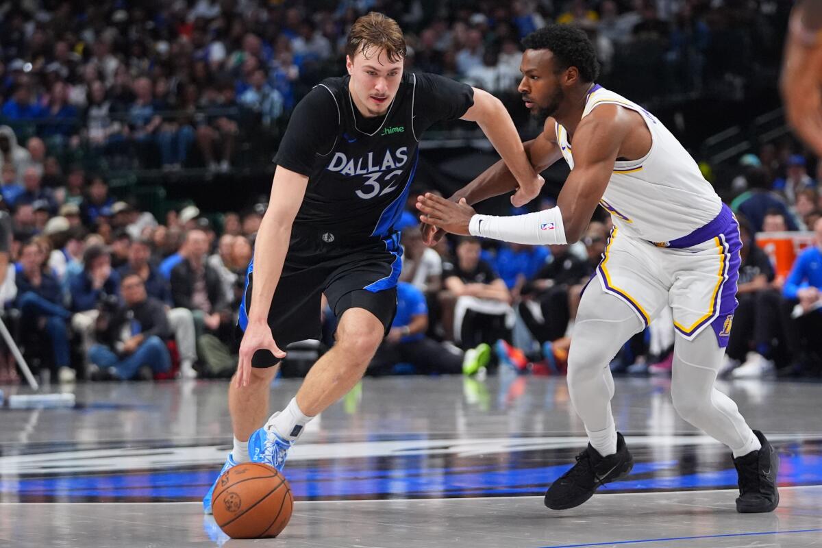 Dallas Mavericks forward Cooper Flagg, left, drives against Lakers guard Bronny James.