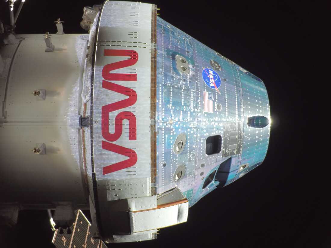A photo of NASA's Orion space capsule taken by a remote camera mounted on one of its solar arrays as it sped towards the moon. The four astronauts will loop around the moon on Monday and also venture farther into space than any humans before.