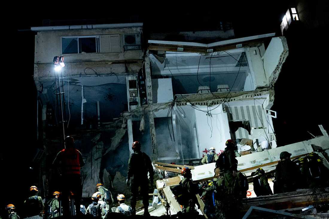 HAIFA, ISRAEL, - APRIL 5: Israeli emergency responders search for missing people at the site of an apparent Iranian ballistic missile strike on April 5, 2026 in Haifa, Israel.